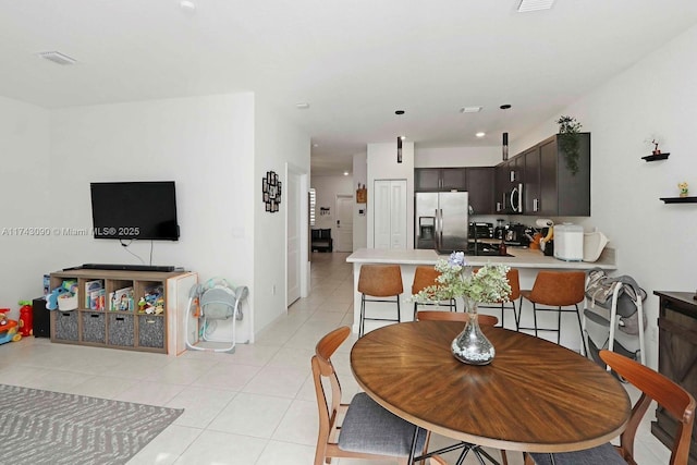 dining room with visible vents and light tile patterned floors