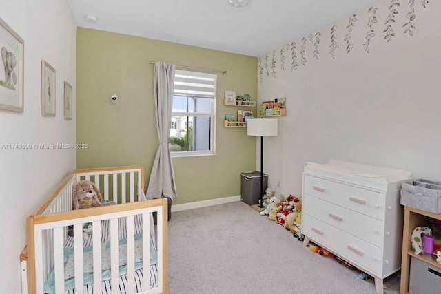 bedroom featuring light carpet, baseboards, and a crib