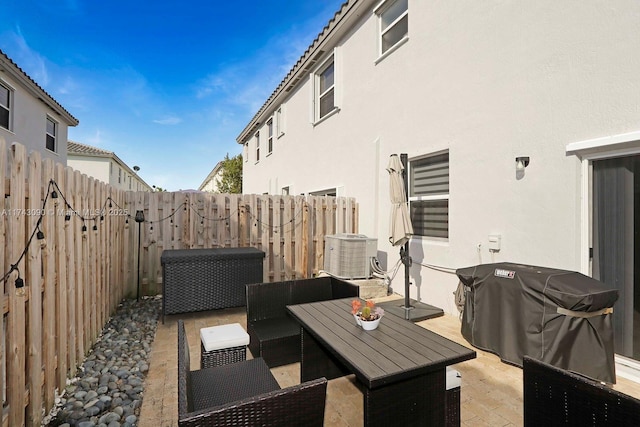 view of patio / terrace featuring an outdoor hangout area, central AC unit, and a fenced backyard