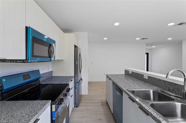 kitchen featuring recessed lighting, visible vents, appliances with stainless steel finishes, light wood-style floors, and a sink