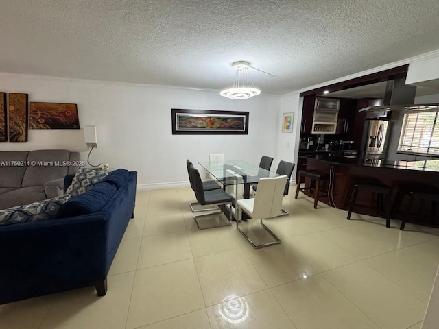 living area with crown molding, baseboards, a textured ceiling, and tile patterned floors