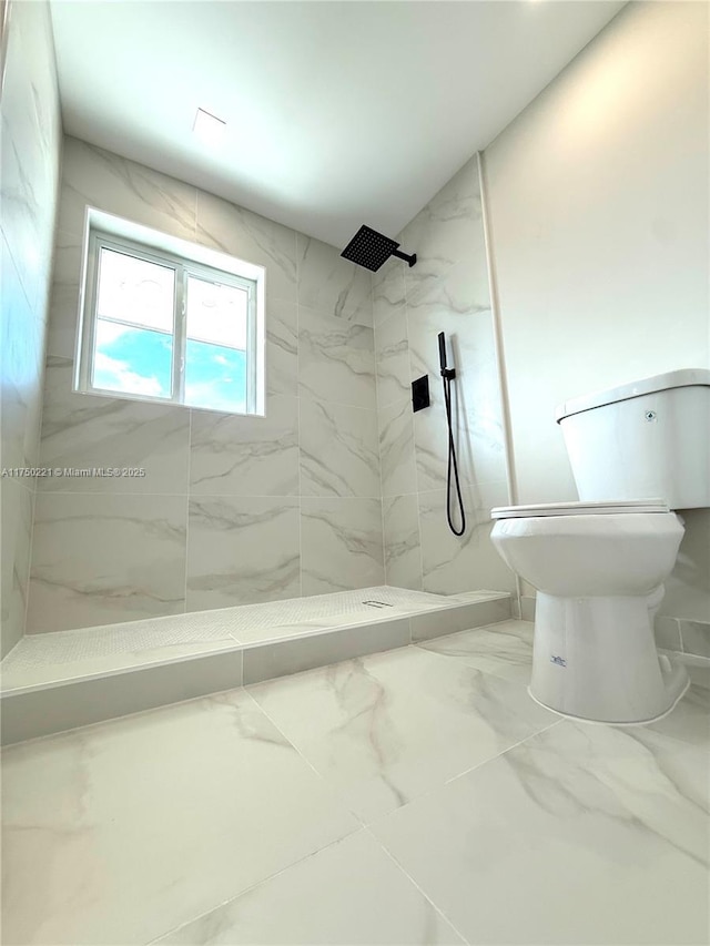 bathroom with marble finish floor, a marble finish shower, and toilet