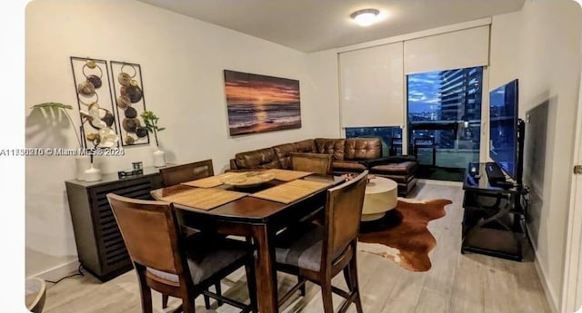 dining space featuring light wood-type flooring