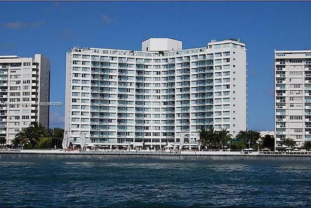 view of property featuring a water view and a city view