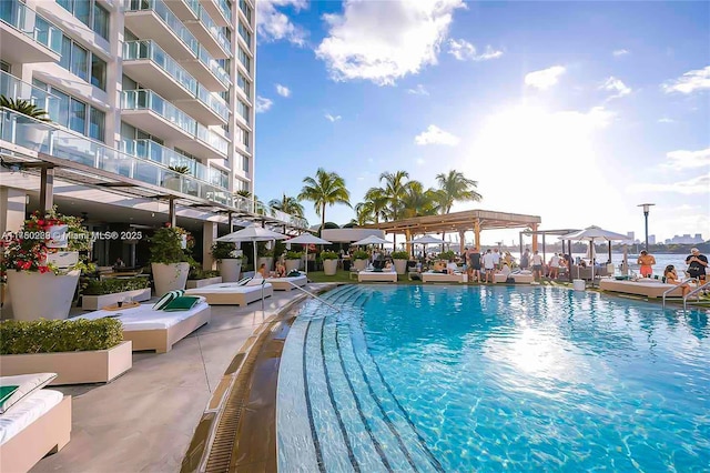 pool featuring a water view and a pergola