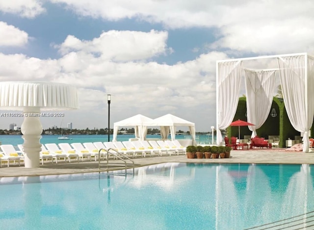 community pool featuring a water view and a gazebo