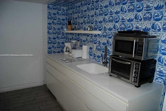 interior space with a sink and wood finished floors