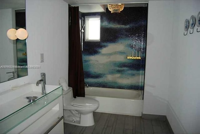 full bath with toilet, washtub / shower combination, wood finished floors, and vanity