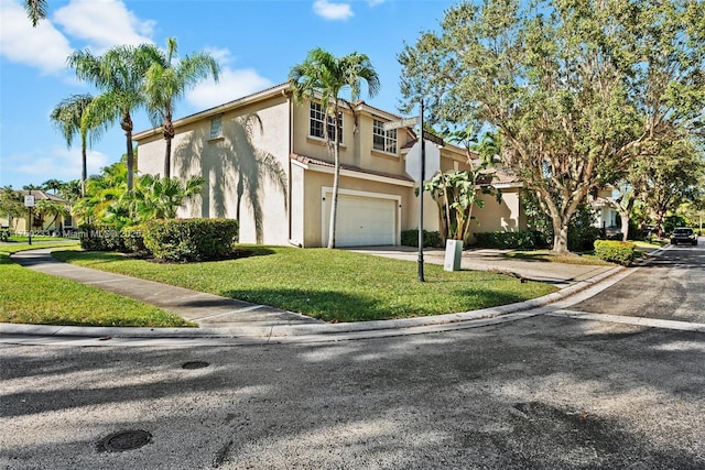 multi unit property with a residential view, a front lawn, concrete driveway, and stucco siding