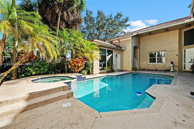 view of pool with a patio and a pool with connected hot tub