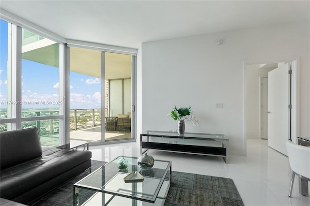 living area featuring light tile patterned floors and a wall of windows