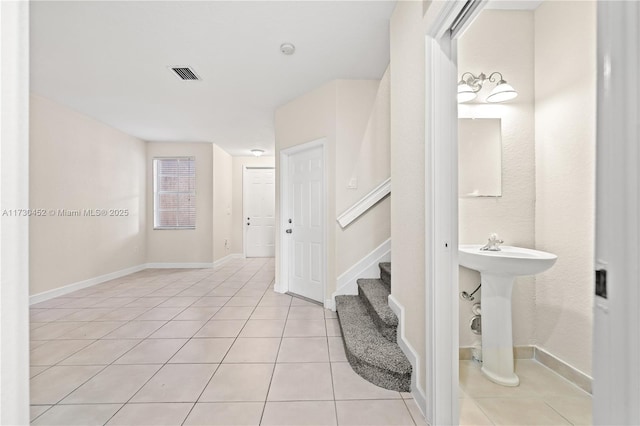 bathroom with visible vents, baseboards, and tile patterned floors