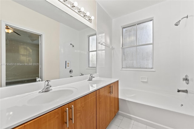 bathroom with a washtub, double vanity, a sink, and tile patterned floors