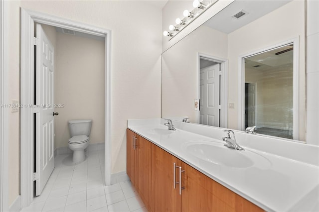 bathroom featuring visible vents, a sink, toilet, and double vanity