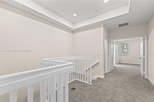 corridor with baseboards, visible vents, carpet flooring, an upstairs landing, and recessed lighting