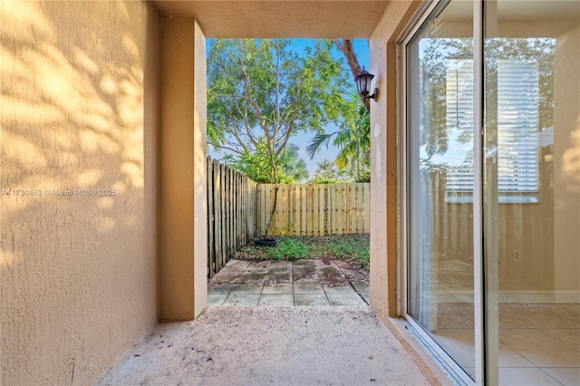 doorway featuring plenty of natural light and light tile patterned flooring