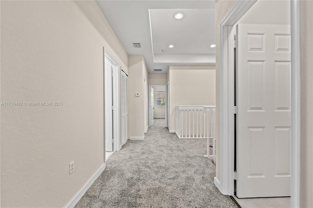 hall featuring recessed lighting, baseboards, visible vents, and light colored carpet