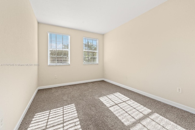 unfurnished room with carpet flooring and baseboards