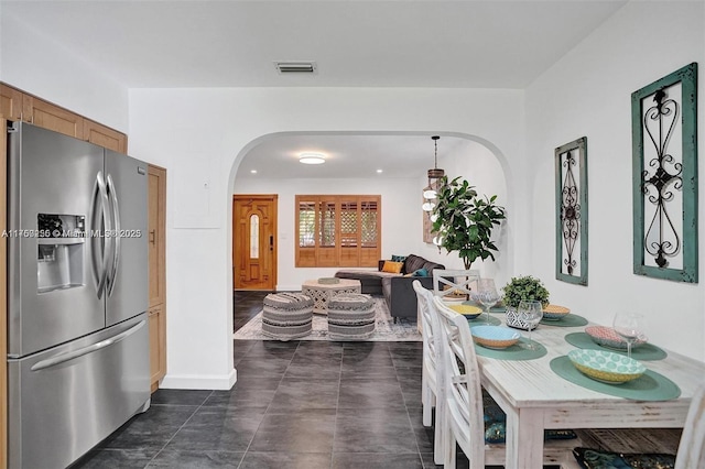 dining room featuring visible vents and arched walkways