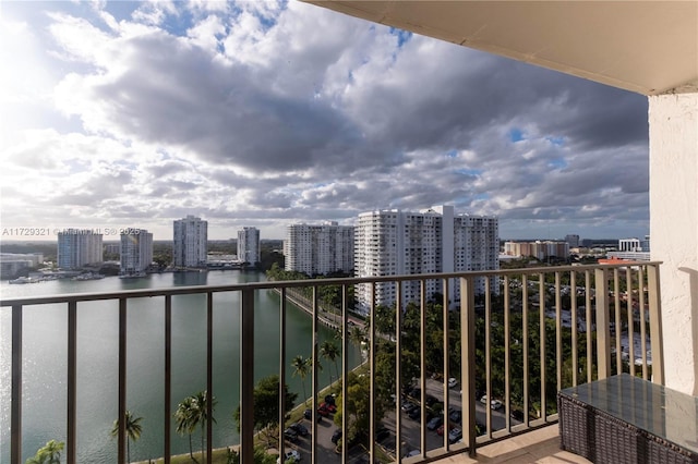 balcony featuring a view of city and a water view