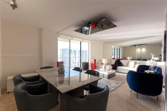 dining space featuring floor to ceiling windows and a city view