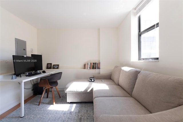 office area featuring electric panel and baseboards