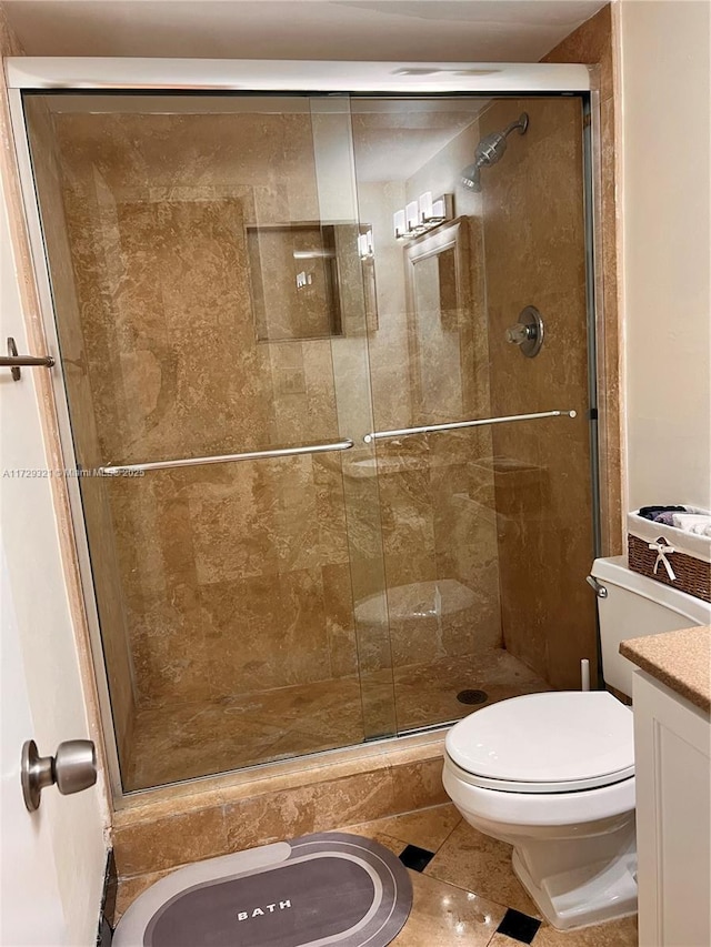 full bath featuring toilet, a shower stall, and vanity