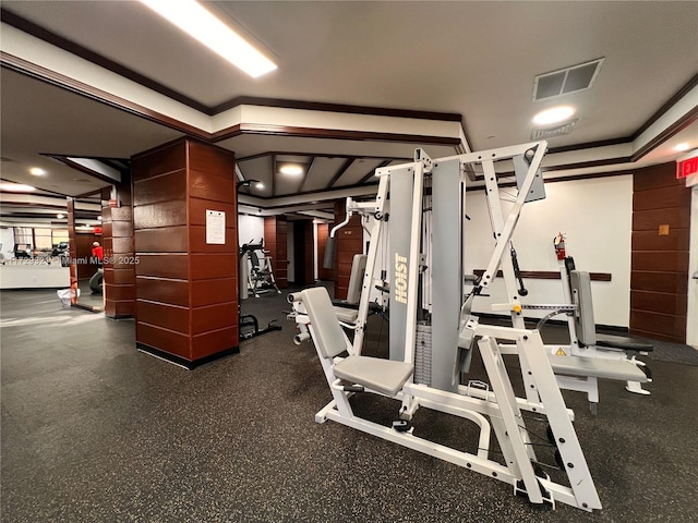 workout area with ornamental molding and visible vents