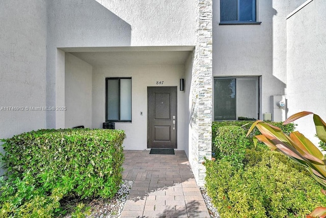 property entrance with stucco siding