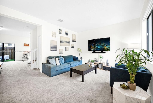 living room with carpet, visible vents, and plenty of natural light