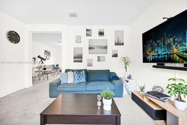 carpeted living area featuring visible vents and baseboards