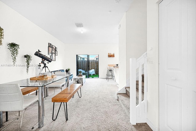 dining area featuring stairs, carpet flooring, and visible vents