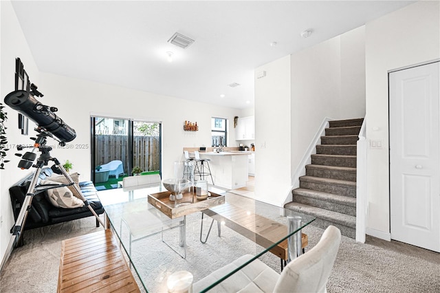 living room with visible vents and stairway