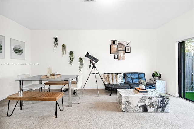 carpeted living area with baseboards