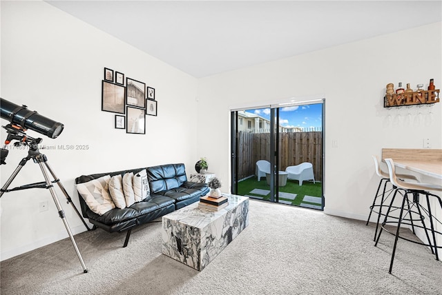 carpeted living room featuring baseboards