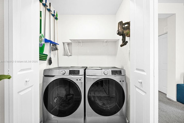 washroom with carpet floors, laundry area, and washer and dryer