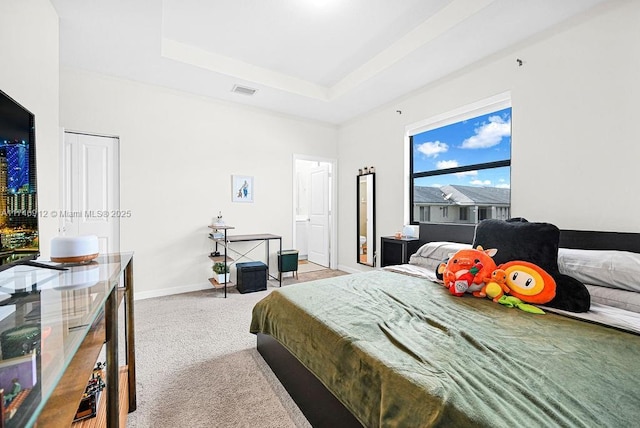 bedroom with a raised ceiling, light carpet, visible vents, and baseboards