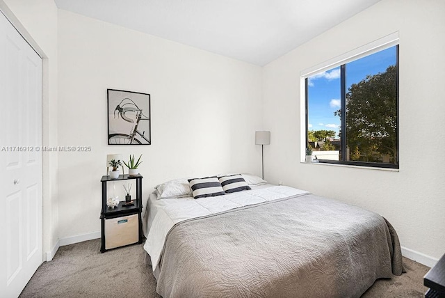 bedroom featuring baseboards and light colored carpet