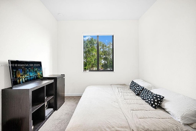 carpeted bedroom featuring baseboards