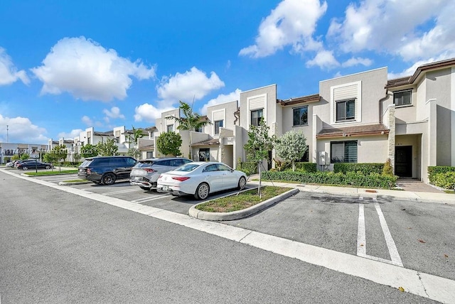 uncovered parking lot featuring a residential view