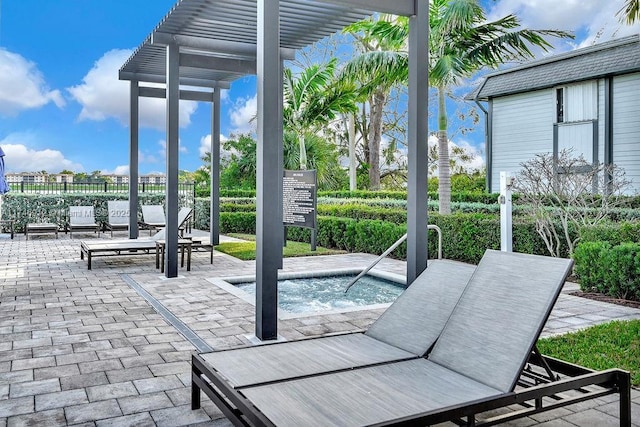 view of patio / terrace with a pergola, fence, and a hot tub