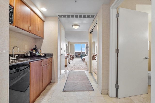 interior space with visible vents, a sink, and light tile patterned flooring