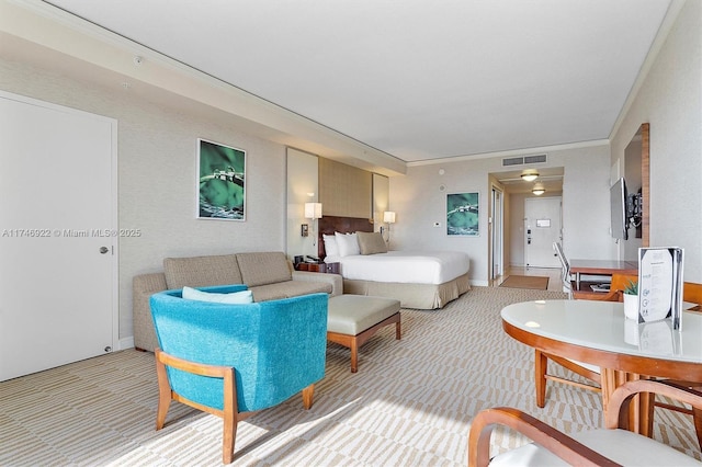 bedroom featuring crown molding, visible vents, and light colored carpet