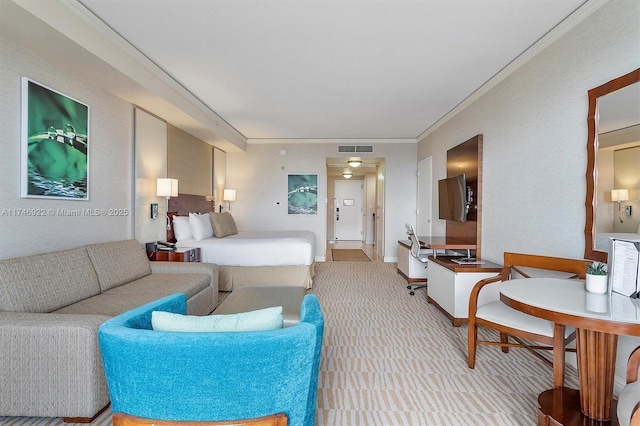 bedroom with ornamental molding, visible vents, light carpet, and baseboards