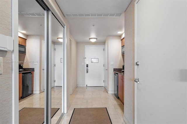 hall featuring visible vents and light tile patterned flooring