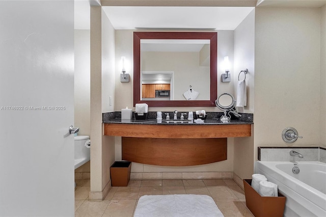 full bathroom with tile patterned floors, vanity, baseboards, and a bath