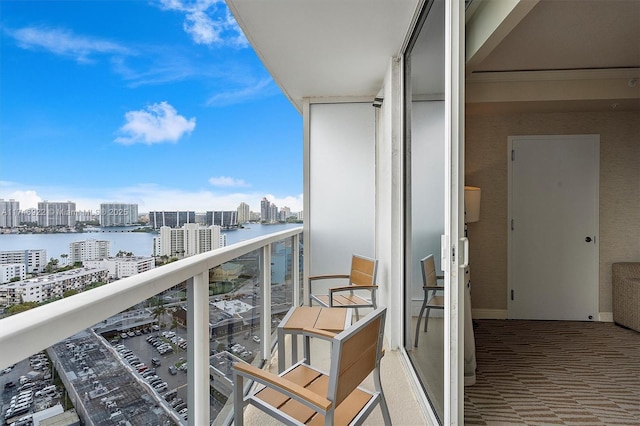 balcony featuring a view of city and a water view