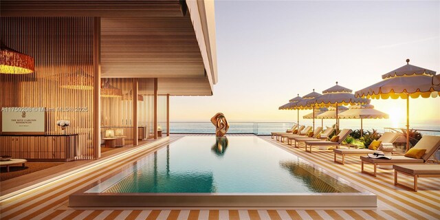 1671 Collins Ave Unit 5A, Miami Beach, FL 33139 - pool at dusk featuring a community pool and a water view