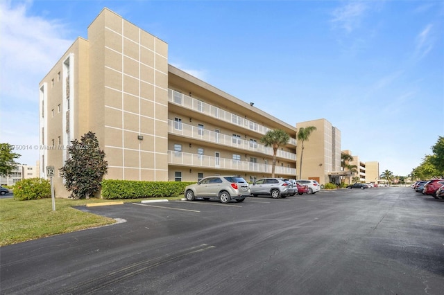 view of building exterior featuring uncovered parking