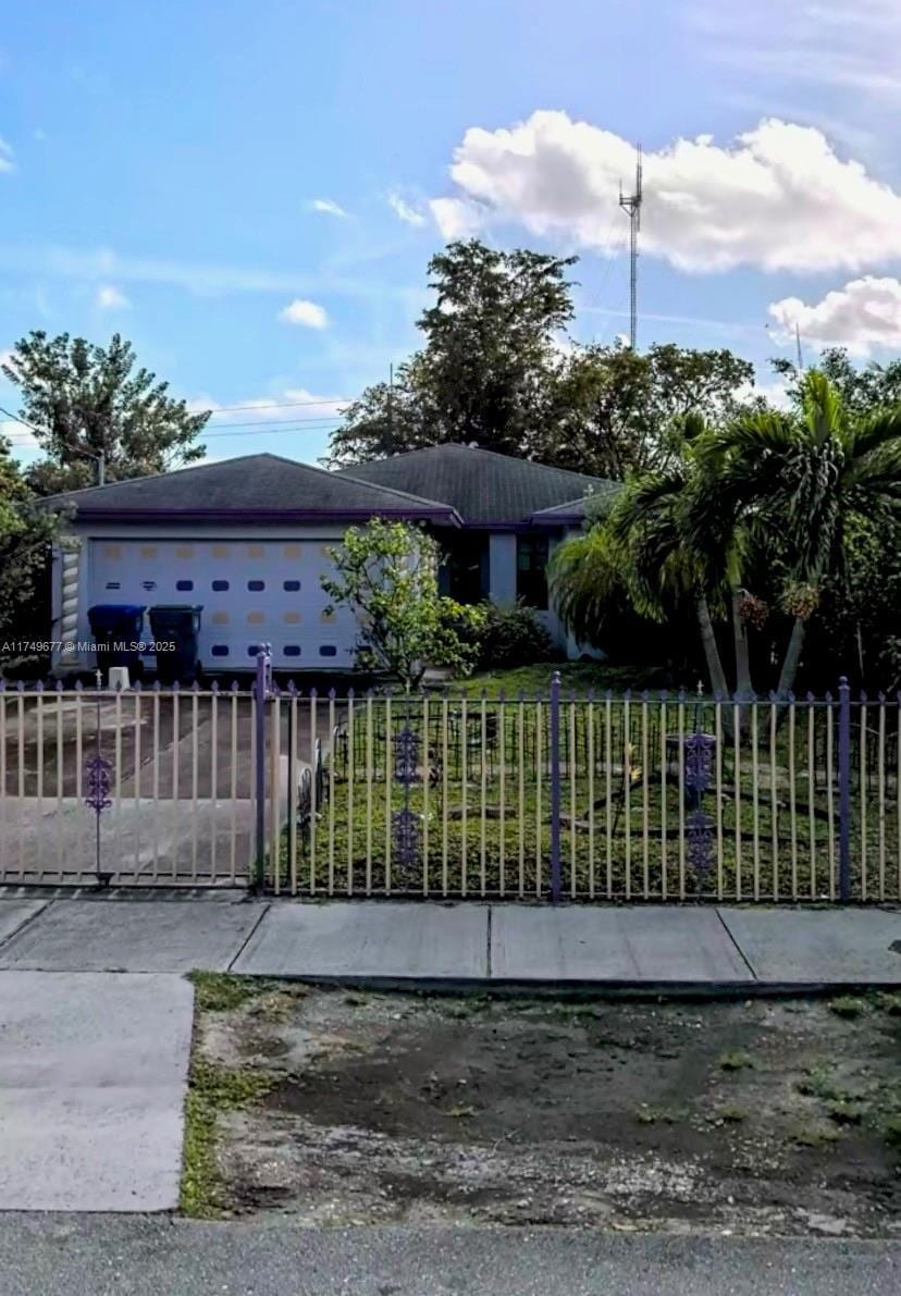 view of gate featuring a fenced front yard